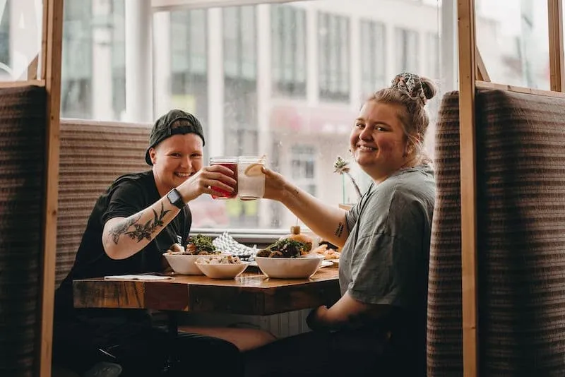 Guests enjoying breakfast in a booth at EATology